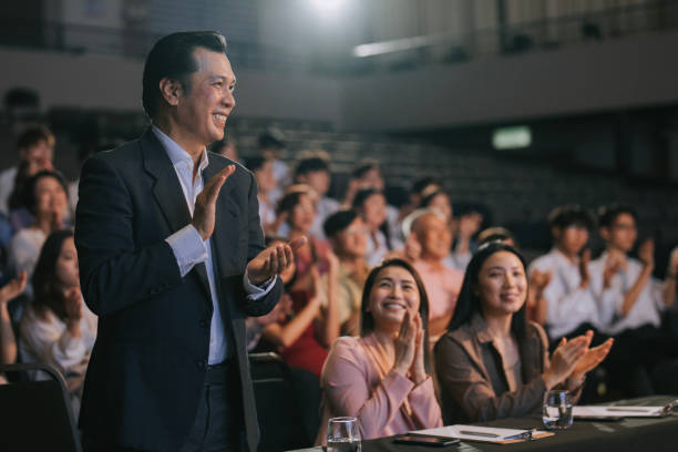 istock Asian panel judge stand up and applauding to stage performance competition in front of audience 2191026771