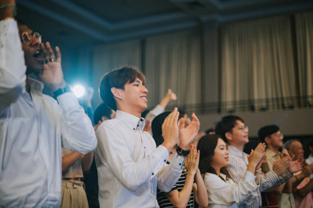 istock Enthusiastic Asian mixed aged audience standing applause cheering at auditorium 2191026780