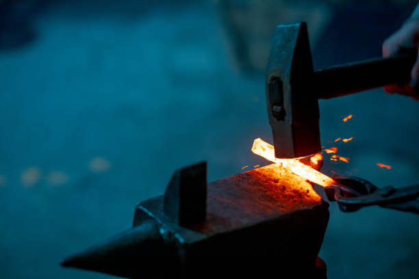 istock a blacksmith's hammer strikes molten iron, the work of a blacksmith 2191026808