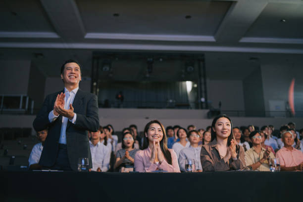 istock Asian panel judge stand up and applauding to stage performance competition in front of audience 2191027059