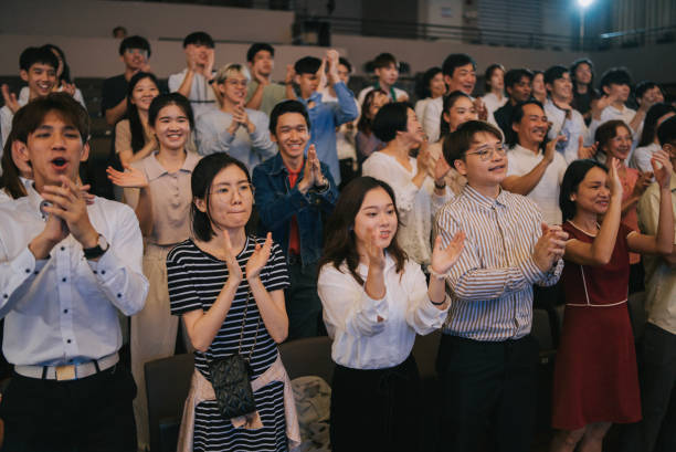istock Enthusiastic Asian mixed aged audience standing applause cheering at auditorium 2191027157