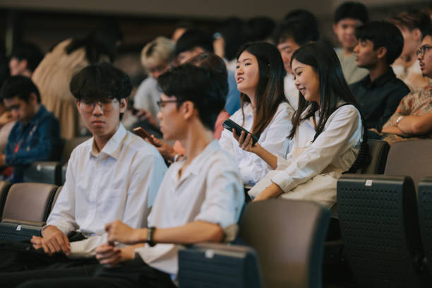 istock Asian young audience sitting in auditorium waiting for the stage performance to start 2191027304