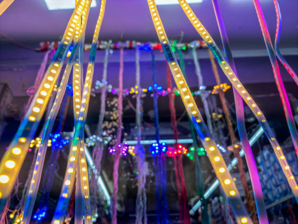 A row of colorful lights hanging from the ceiling. The lights are in different colors and are arranged in a way that they are not touching each other