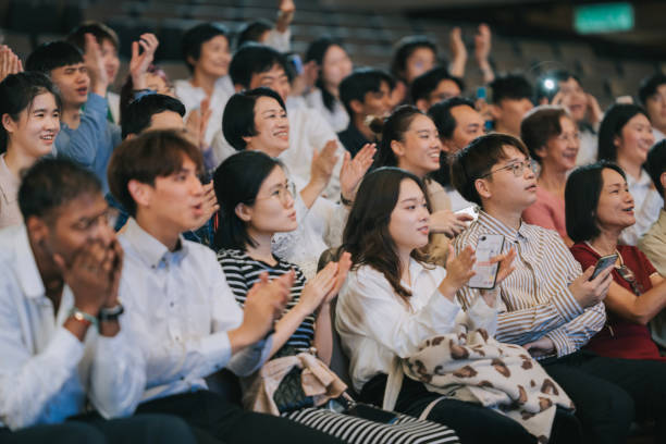 istock Enthusiastic Asian mixed aged audience applause cheering at auditorium 2191027350