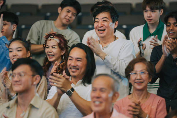 istock Enthusiastic Asian mixed aged audience clapping hands cheering at auditorium 2191027529