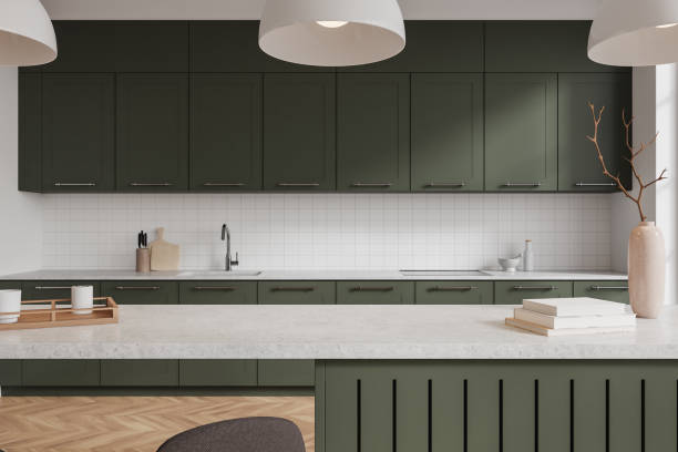 istock Modern kitchen interior with green cabinets, minimalist decor, and white countertops in luxury home. 3D Rendering 2191028132