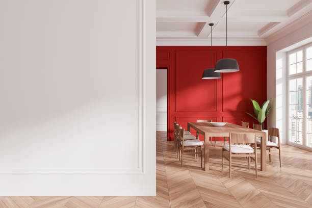 istock Modern dining room with a blank wall, red accent wall, wooden table, chairs, and pendant lights. Elegant interior design concept. 3D Rendering 2191028544