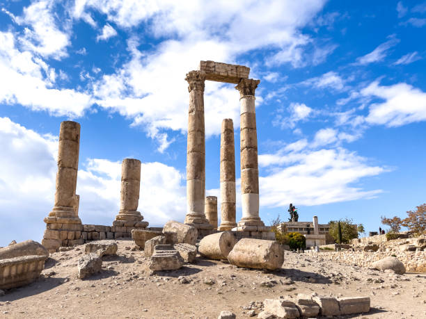 Historic Roman ruins featuring standing stone columns on a sunny day, symbolizing ancient culture and architectural heritage.