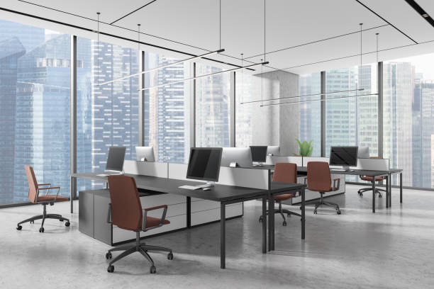 istock Modern office space with computer desks and chairs, large city view windows in a sleek contemporary design. 3D Rendering 2191030750
