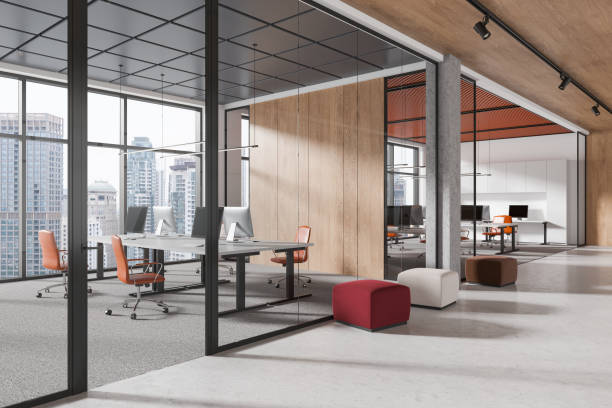 istock Stylish coworking interior with armchairs and pc computers in row, window 2191030780