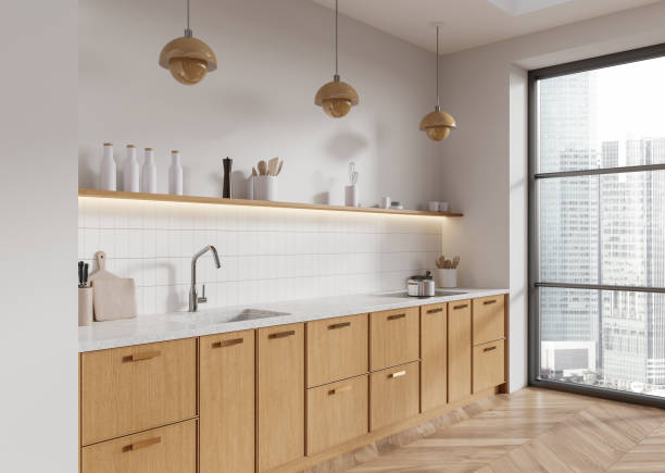 istock Modern kitchen interior with wooden cabinets, minimalistic design, large window, and pendant lights in a contemporary home. 3D Rendering 2191031009
