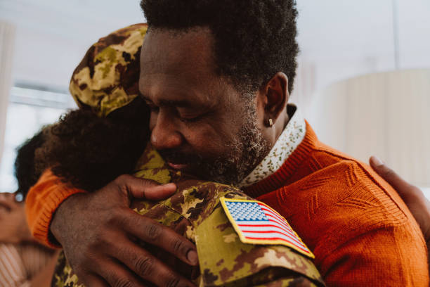 Us Veteran woman leaving for military service. Young female soldier leaving and greeting the family after the holidays.
