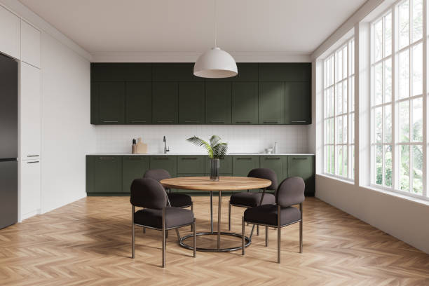 istock Modern kitchen interior with dark green cabinets and wooden table in bright room with large windows. 3D Rendering 2191031376