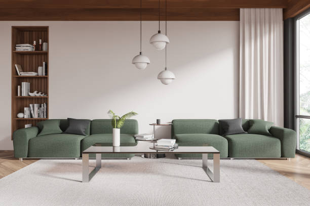 istock Modern living room interior with green sofas, minimalist coffee table, and wooden shelving unit. 3D Rendering 2191031413