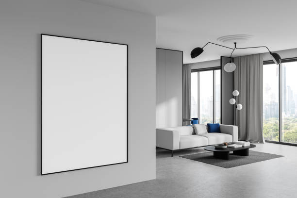 istock Blank poster mockup on a modern living room wall with large windows and minimalist decor. 3D Rendering 2191031568