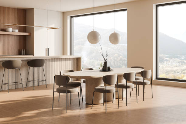 istock Modern kitchen and dining room with minimalist decor and large windows in a neutral color palette. 3D Rendering 2191031614