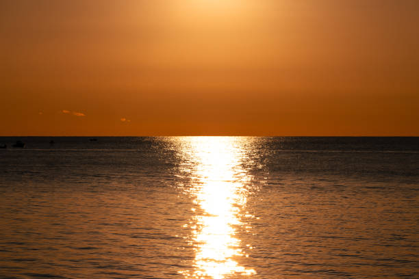 istock Golden Sunset Reflection Over Calm Ocean Waters 2191034935