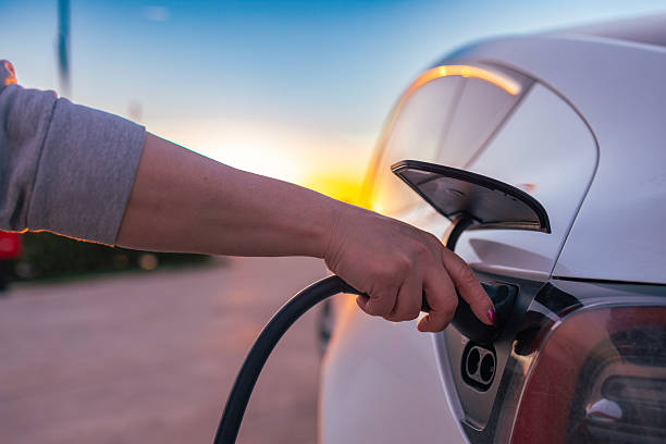 istock Unplugging Electric Car Charger at Sunset 2191035150