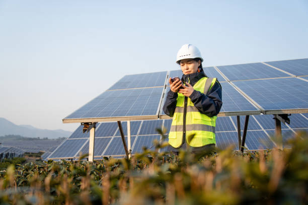 istock asian female using smart phone in solar power station 2191035570