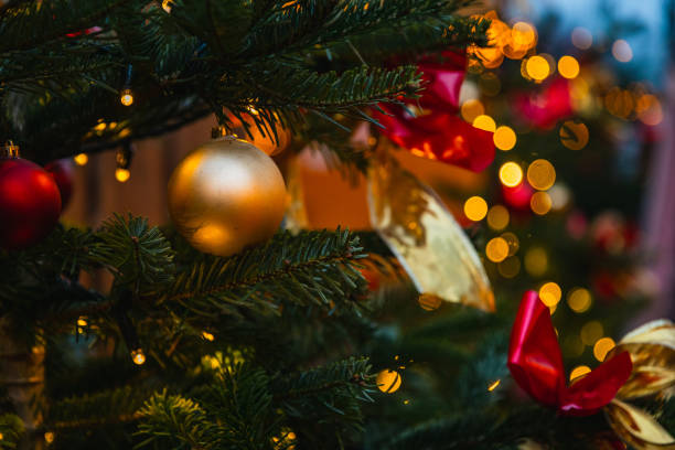 istock Golden Bauble and Twinkling Lights on Christmas Tree 2191035785