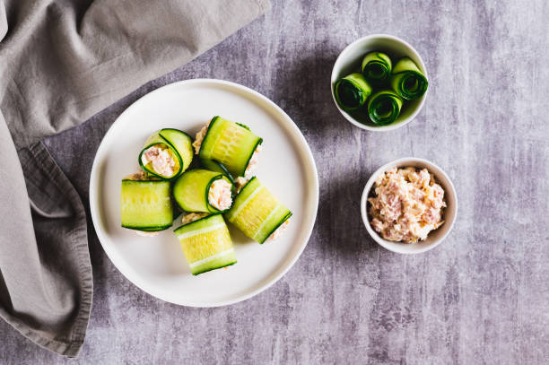 istock Appetizing cucumber rolls made from tuna salad, egg and cheese on a plate top view 2191035989
