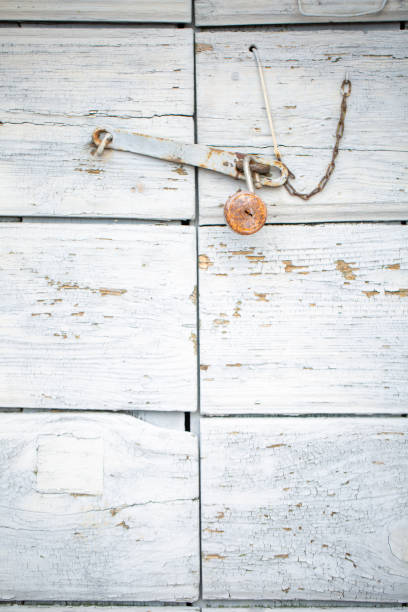 istock Close-up of padlock on rustic old wood door, background 2191036097