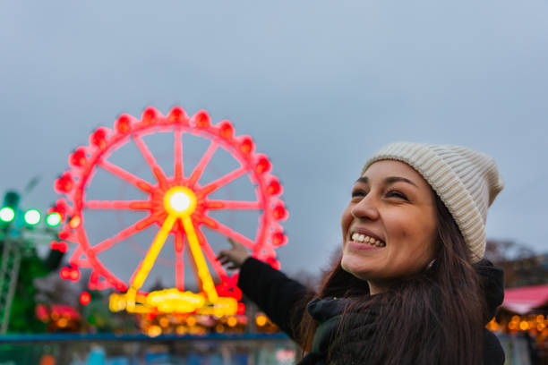 istock Pointing at the Illuminated Ferris Wheel at Berlin's Christmas Market 2191036205