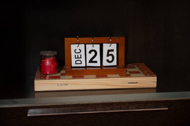 istock Wooden block calendar with December 25th displayed next to red candle 2191036355