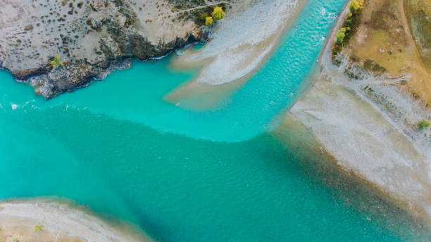 istock Turquoise river flowing into a lake in a mountain valley landscape 2191037770