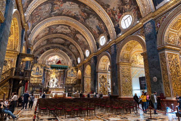 The ornate interior of St. John's Co-Cathedral in Valletta, Malta, featuring intricate baroque design and rich artwork.