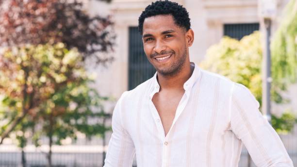 istock Happy man smiling while looking at camera in city 2191048467