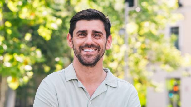 istock Happy man looking at camera in city park during daytime 2191048789