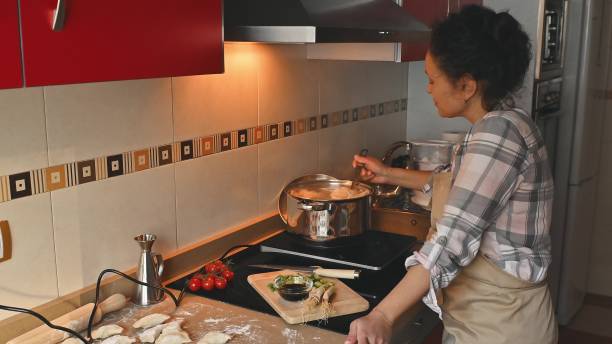 istock Homemade Cooking Scene Featuring Dumpling Preparation and Steaming Pots 2191049602