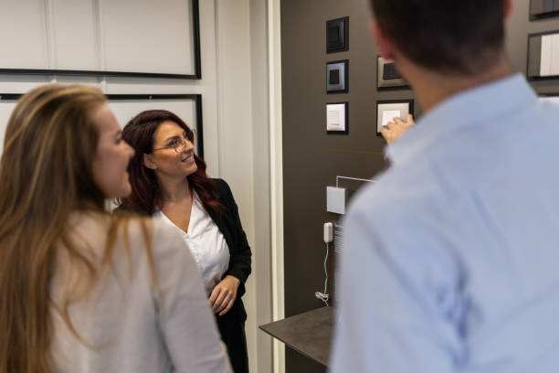 istock Female real estate agent talking with her clients at building hallway 2191050853