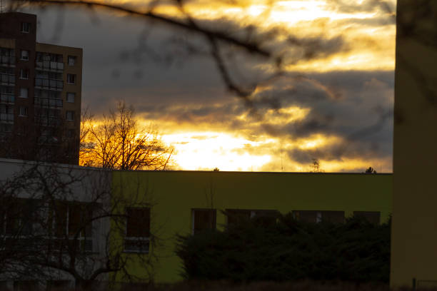 Dark clouds are scudding across the sky over ctiy buildings on summer morning.