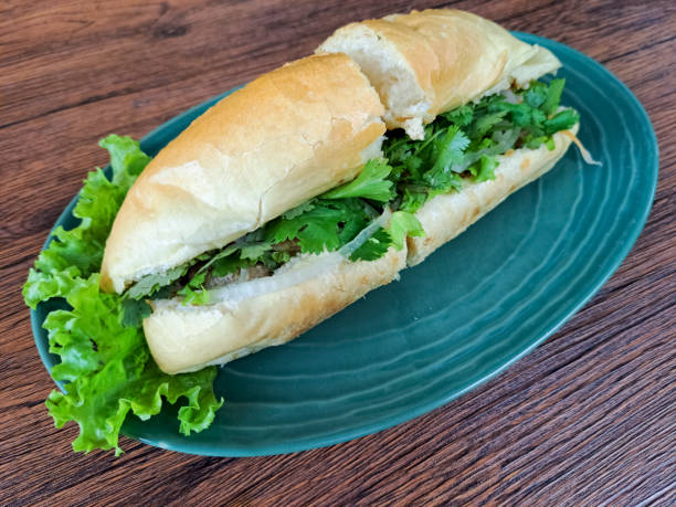 istock Tasty Chicken Banh Mi Is A Vietnamese Sandwich Bread Filled with Complementary Vegetables, Pate Sauce, Satay Sauce, Beef Floss and Grilled Chicken Marinated with Lemongrass Seasoning. Vietnam Food Menu. 2191052587