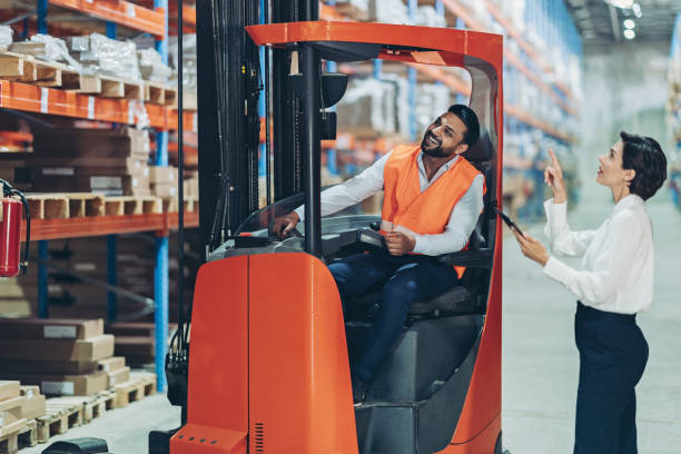 istock Warehouse manager giving instructions to a forklift driver 2191053839