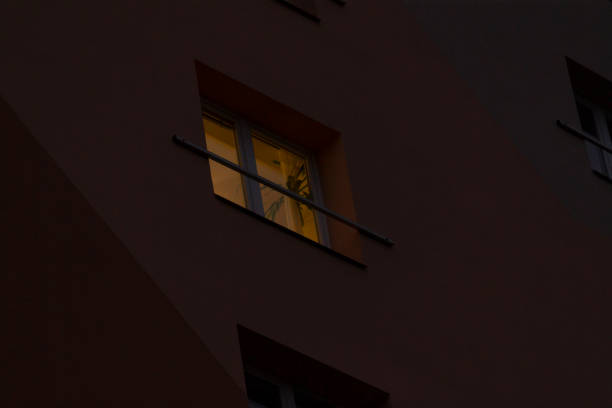 istock A darkened building stands tall with a window illuminating at night 2191054579