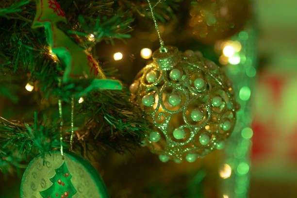 A beautiful closeup image of a beautifully decorated Christmas tree adorned with vibrant ornaments and twinkling lights, creating a festive atmosphere