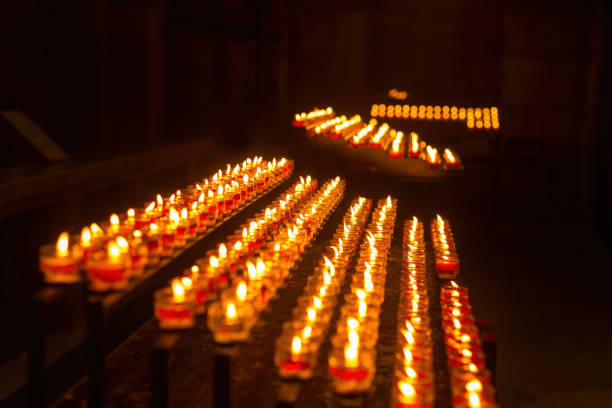 Close-up of illuminated tea lights in darkroom