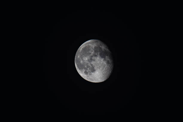 istock Waxing gibbous moon in dark night sky 2191058724