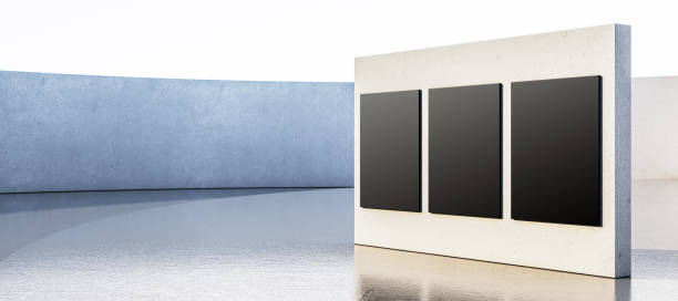 Modern blank concrete wall with black panels in open space, reflective floor, and light sky backdrop, ideal for exhibition or design. 3D Rendering