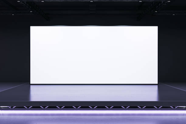 istock Blank white screen on stage with dark interior and modern lighting setup, perfect for presentations or business displays. 3D Rendering 2191058753