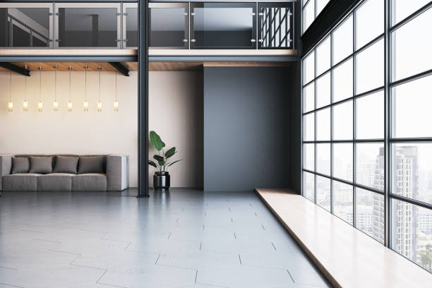 istock Modern interior with spacious loft design, glass windows, and city view featuring a sofa, potted plant, and suspended lighting. 3D Rendering 2191061378
