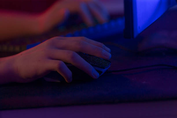 istock An individual is operating a computer mouse and keyboard within a dark room 2191062526