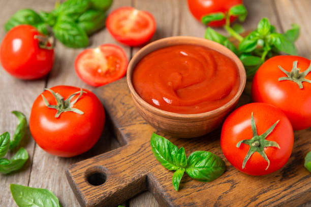 istock Fresh cherry tomatoes and fresh green basil on a textured background. Tomato sauce. Vegan. Ingredients for salad. Organic food. Place for text. Copy space. 2191063703