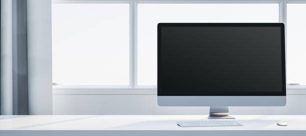 istock Minimalistic desktop setup with a black screen monitor, keyboard, and mouse on a white table near a window with curtains. 3D Rendering 2191063762