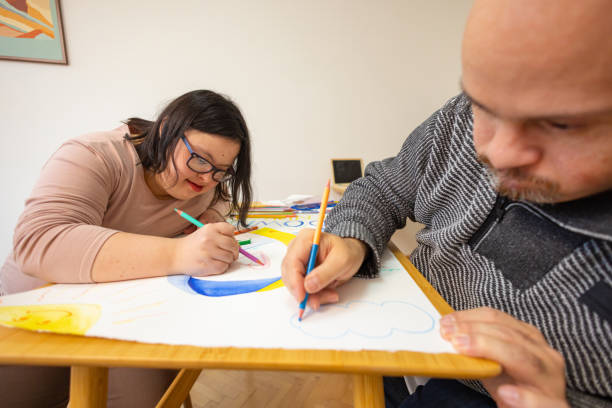 istock Young Women and a Man with Down Syndrome Collaborate 2191063892