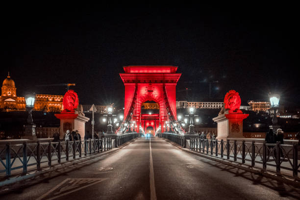 The Lanchid lit up in a red for international AIDS awareness day on Dec 1st 2024. Buda Castle is in the background.