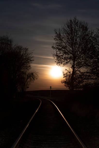 istock Rising full moon over a single railway-line in rural Bavaria, Germany 2191066389